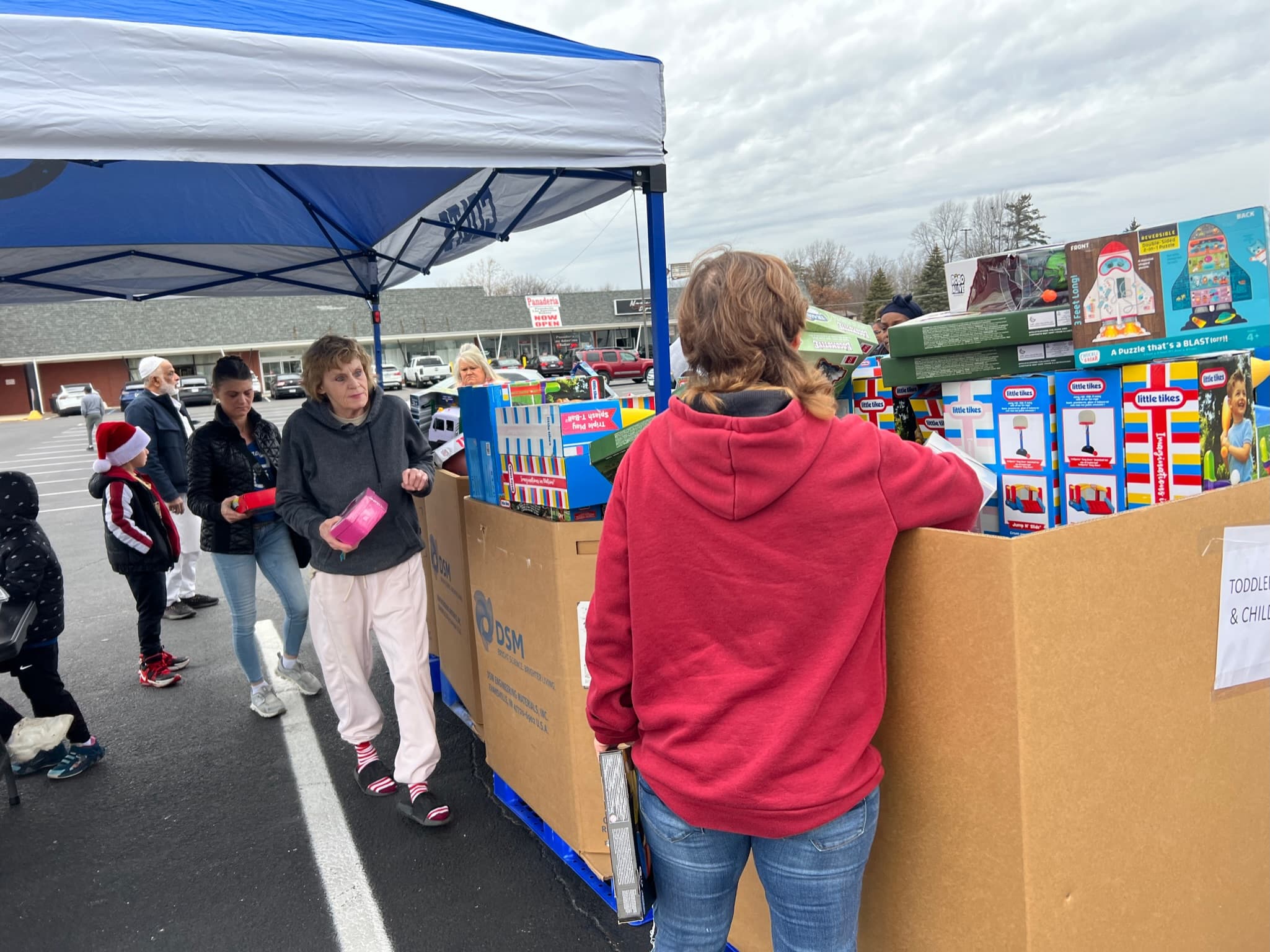 Families and volunteers gathering at a previous Christmas Toy Drive event