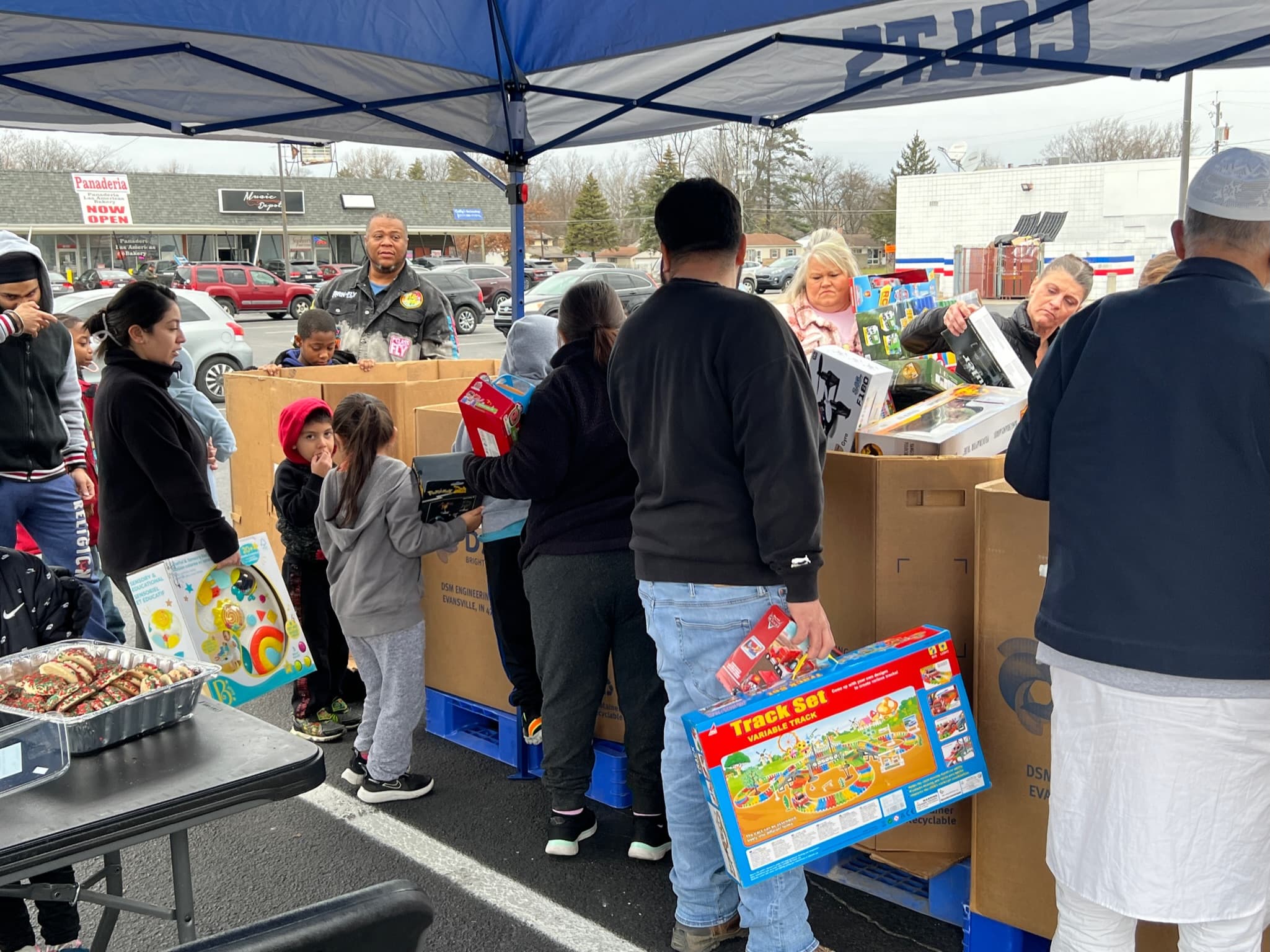 Kids and parents receiving toys at the Christmas Toy Drive
